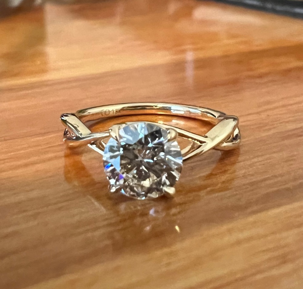 Customer photo of a yellow gold twist solitaire engagement ring with a round diamond, front view